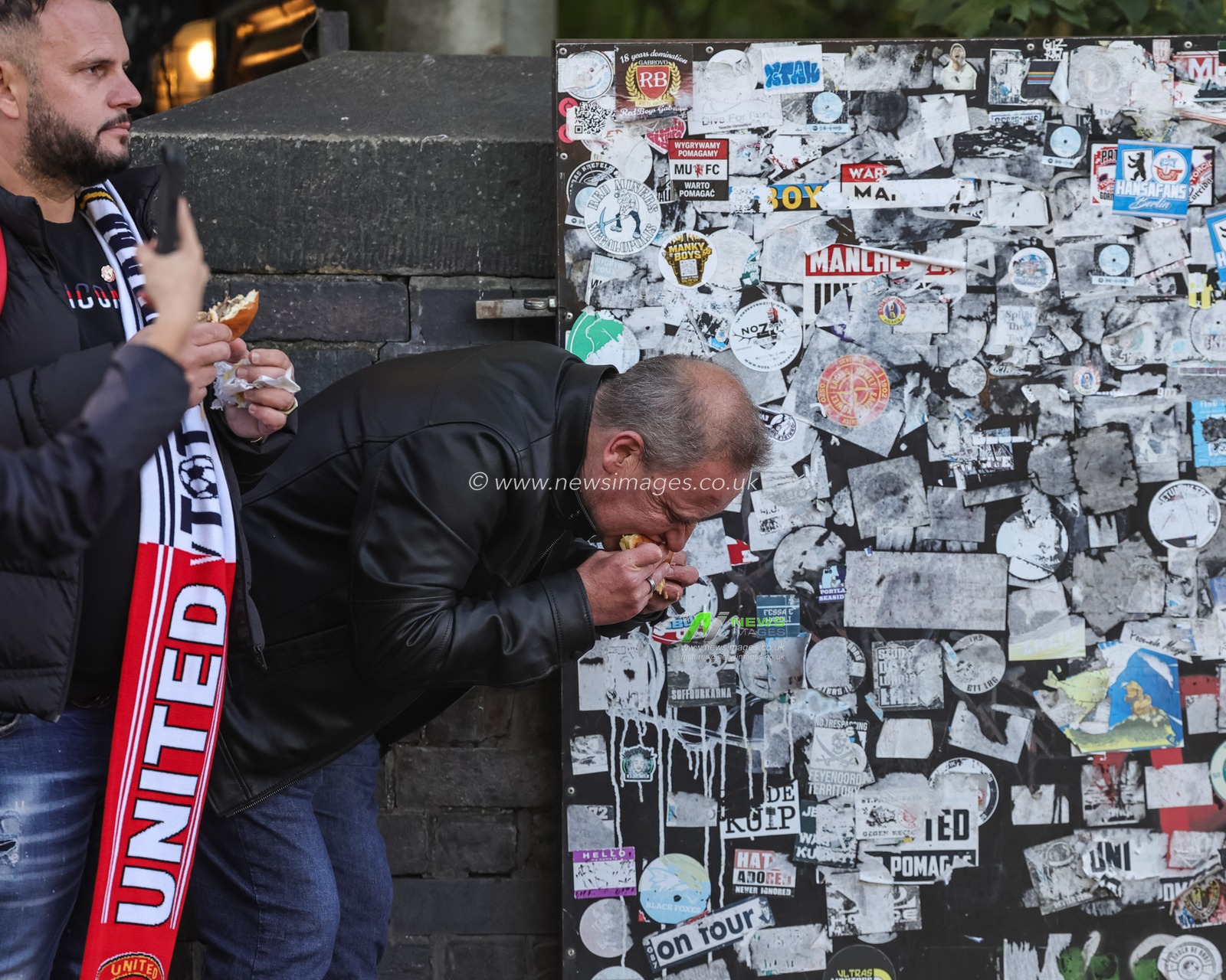 Manchester United fans grab a bite to eat during the Premier League match Manchester United vs Tottenham Hotspur at Old Trafford, Manchester, United Kingdom on 10 October 2026

(Photo by Mark Cosgrove/News Images)