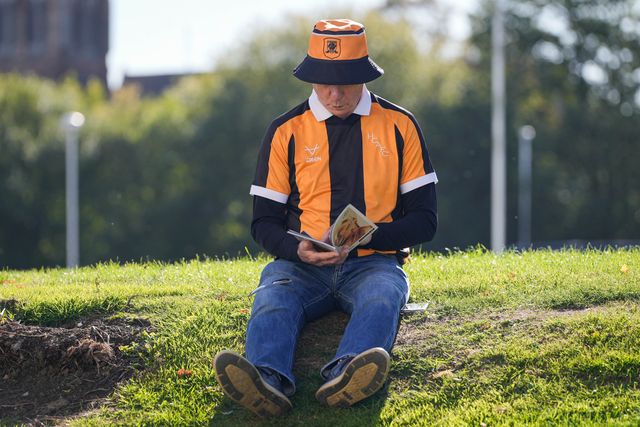 Hull city fans reads the match day program outside the stadium during the Premier League match Hull City vs Everton at MKM Stadium, Hull, United Kingdom on 11 October 2026

(Photo by Maynard Manyowa/News Images)