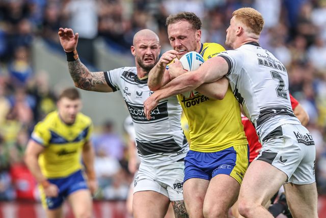 Ben Currie of Warrington Wolves is tackled during the Betfred Super League round 16 match Warrington Wolves vs Hull FC at Halliwell Jones Stadium, Warrington, United Kingdom, 28th June 2025

(Photo by Alfie Cosgrove/News Images)