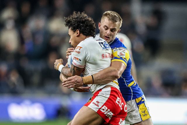 Tristan Sailor of St. Helens is tackled by Cooper Jenkins of Leeds Rhinos during the Betfred Super League play-off Eliminator 1 match Leeds Rhinos vs St Helens at Headingley Stadium, Leeds, United Kingdom, 27th September 2025

(Photo by Alfie Cosgrove/News Images)