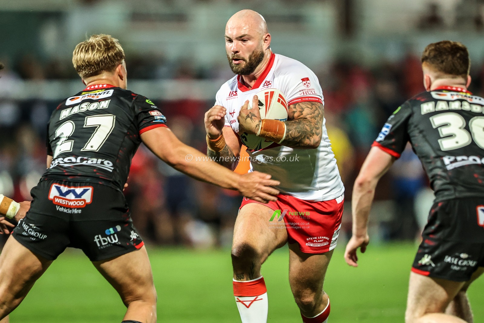 Sam Luckley of Hull KR is tackled by Lukas Mason of Wigan Warriors and George Marsden of Wigan Warriors during the Betfred Super League round 12 match Hull KR vs Wigan Warriors at Sewell Group Craven Park, Hull, United Kingdom on 21 May 2026

(Photo by Alfie Cosgrove/News Images)