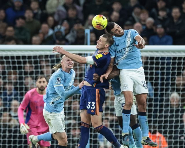 Rodrigo of Manchester City heads the ball clear of his defensive area as Dan Burn of Newcastle Untied pressures during the Premier League match Manchester City vs Newcastle Untied at Etihad Stadium, Manchester, United Kingdom on 21 February 2026

(Photo by Mark Cosgrove/News Images)