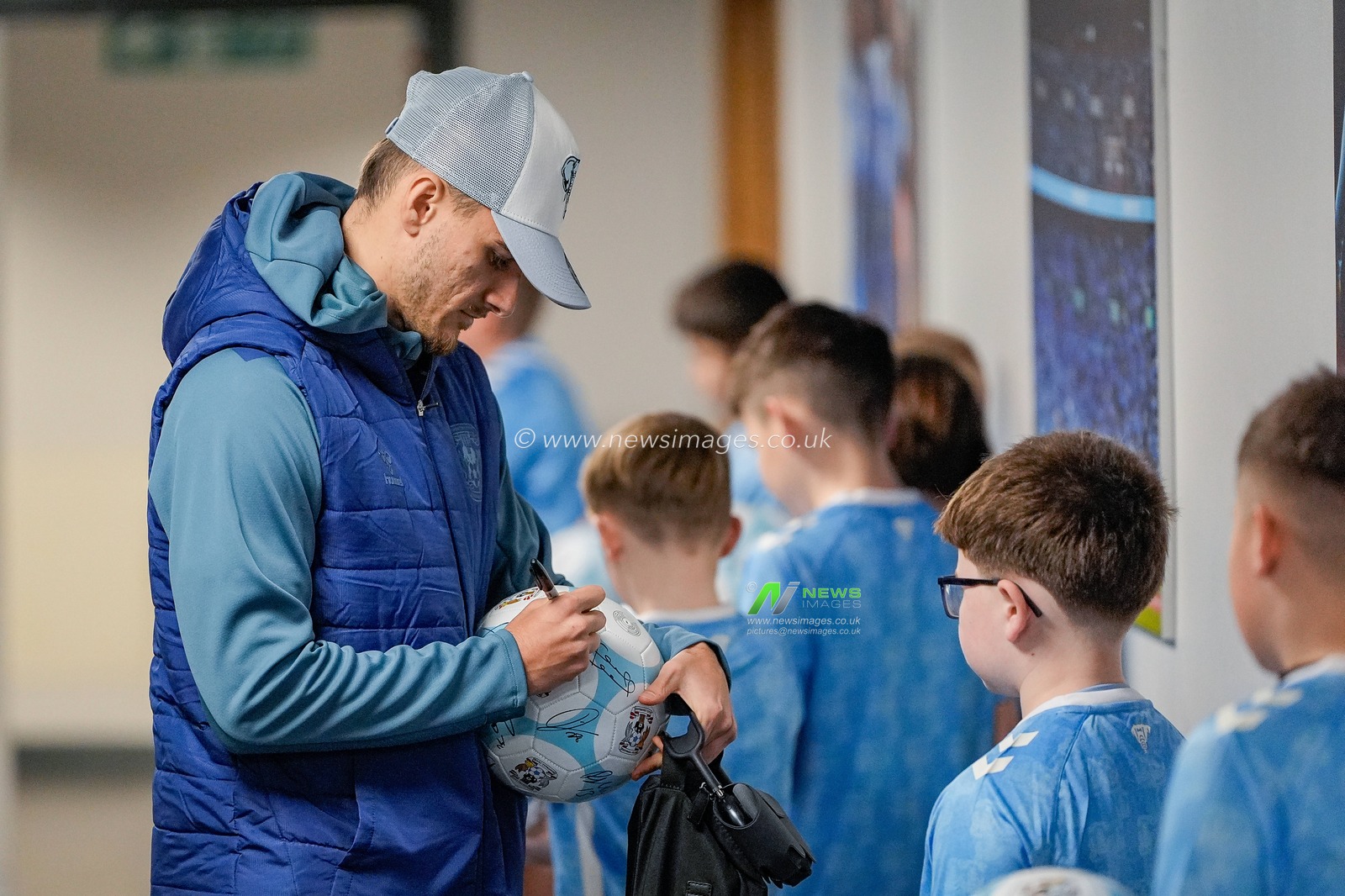 Miguel Brau, of Coventry City signs a ball for mascots arrives for the game during the Sky Bet Championship match Coventry City vs Swansea City at Coventry Building Society Arena, Coventry, United Kingdom, 26th December 2025

(Photo by Maynard Manyowa/News Images)

*** GER AUT SUI OUT ***