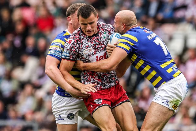 Innes Senior of Leigh Leopards is tackled by James Harrison of Warrington Wolves and Ben Currie of Warrington Wolves during the Betfred Super League round 20 match Leigh Leopards vs Warrington Wolves at Leigh Sports Village, Leigh, United Kingdom on 25 July 2026

(Photo by Alfie Cosgrove/News Images)