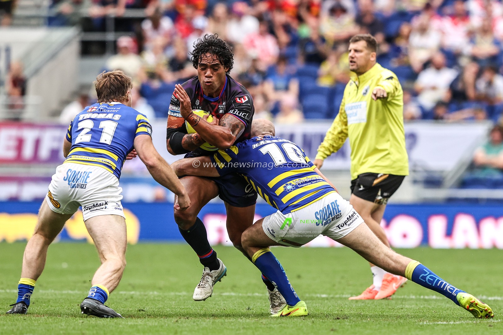 Joe Ofahengaue of Leigh Leopards is tackled by Luke Thomas of Warrington Wolves and James Harrison of Warrington Wolves during the Betfred Super League Magic Weekend match Leigh Leopards vs Warrington Wolves at Leigh Sports Village, Leigh, United Kingdom on 04 July 2026

(Photo by Alfie Cosgrove/News Images)