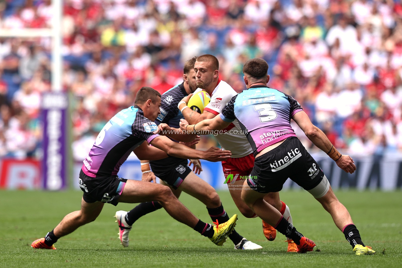 Mikey Lewis of Hull KR is tackled by 	Jake Arthur of Hull FC and Davy Litten of Hull FC during the Betfred Super League Magic Weekend match Hull KR vs Hull FC at Hill Dickinson Stadium, Liverpool, United Kingdom on 04 July 2026

(Photo by Alfie Cosgrove/News Images)