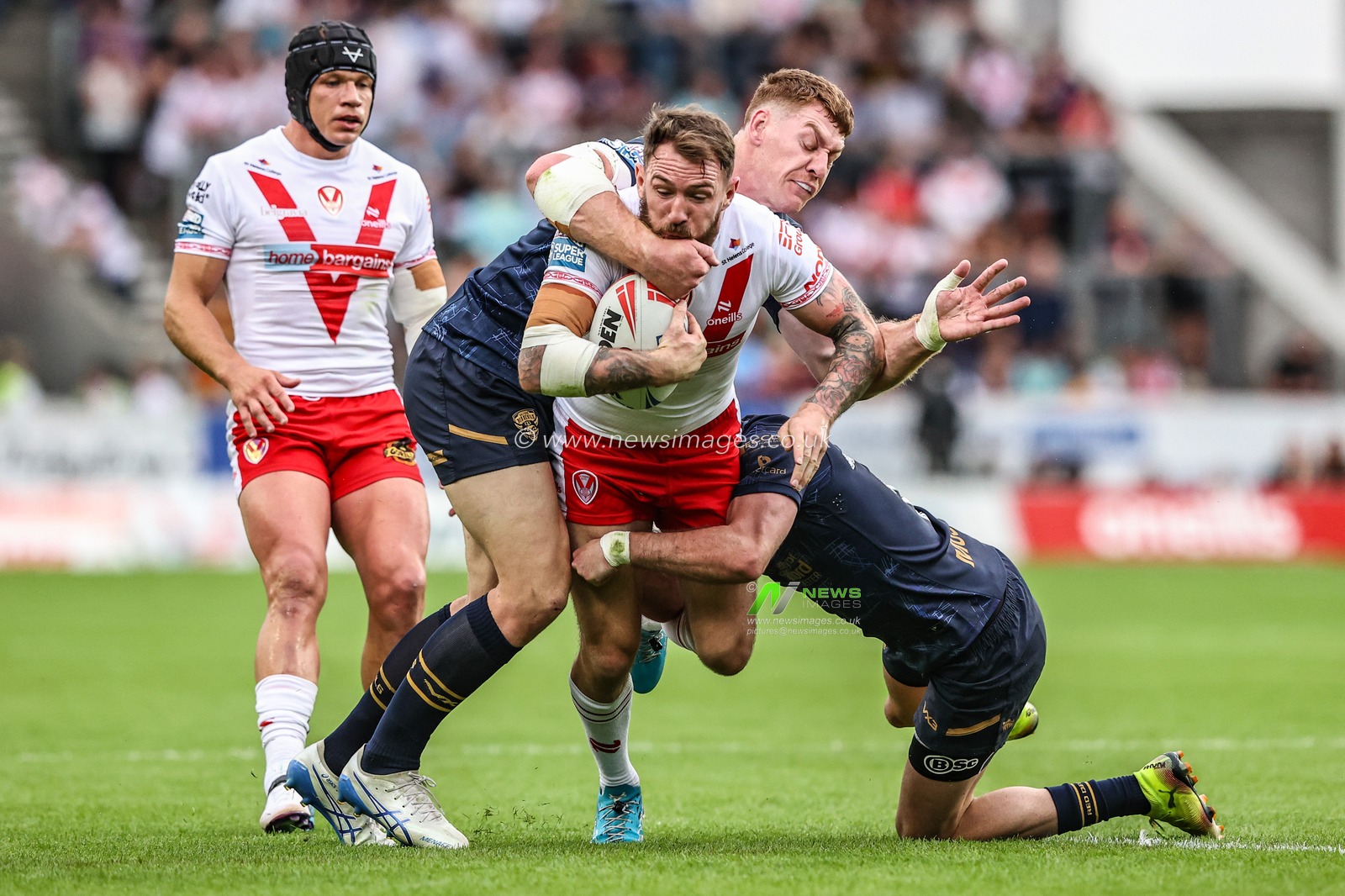 Daryl Clark of St. Helens is tackled during the Betfred Super League round 16 match St Helens vs Salford Red Devils at Totally Wicked Stadium, St Helens, United Kingdom, 29th June 2025

(Photo by Alfie Cosgrove/News Images)
