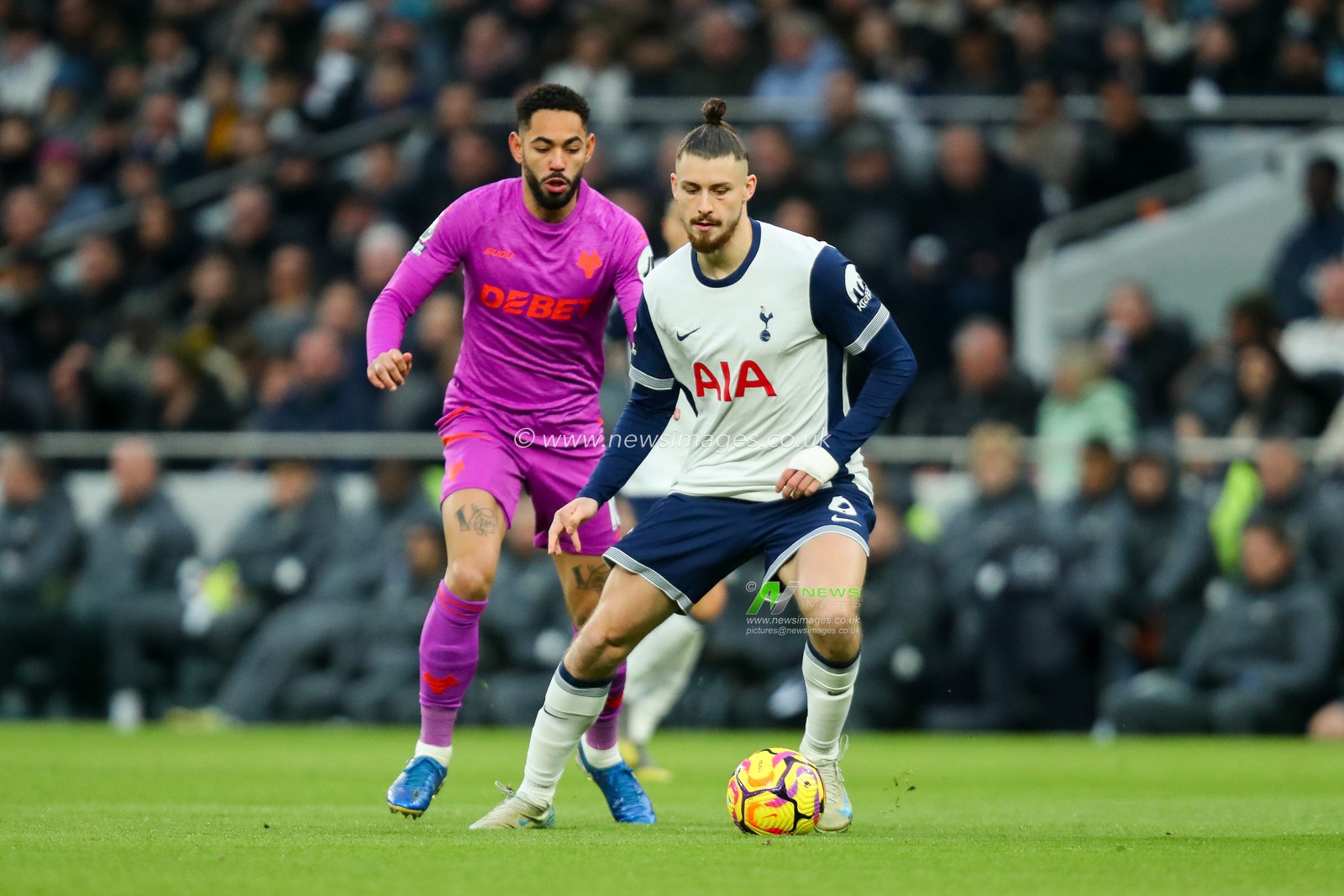Radu DrÄƒguÈ™in of Tottenham Hotspur is put under pressure by Matheus Cunha of Wolverhampton Wanderers during the Premier League match Tottenham Hotspur vs Wolverhampton Wanderers at Tottenham Hotspur Stadium, London, United Kingdom, 29th December 2024

(Photo by Izzy Poles/News Images)