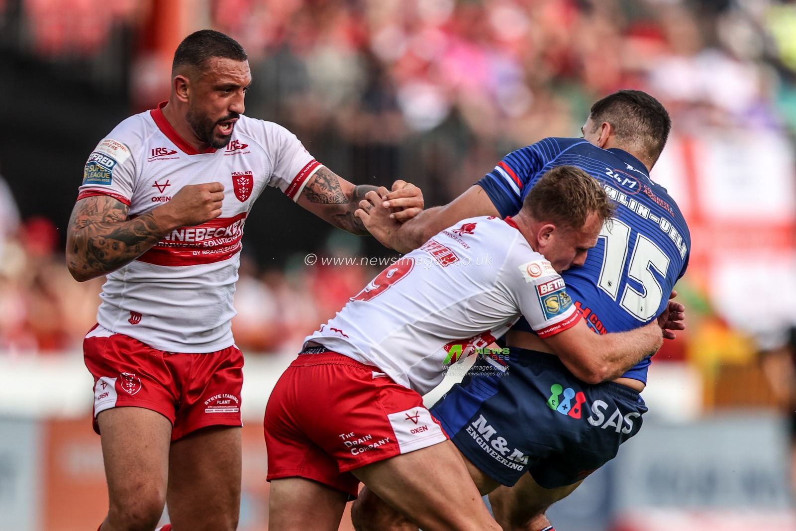 Caleb Hamlin-Uele of Wakefield Trinity is tackled by Elliot Minchella of Hull KR and Jez Litten of Hull KR during the Betfred Super League round 18 match Hull KR vs Wakefield Trinity at Sewell Group Craven Park, Hull, United Kingdom on 11 July 2026

(Photo by Alfie Cosgrove/News Images)