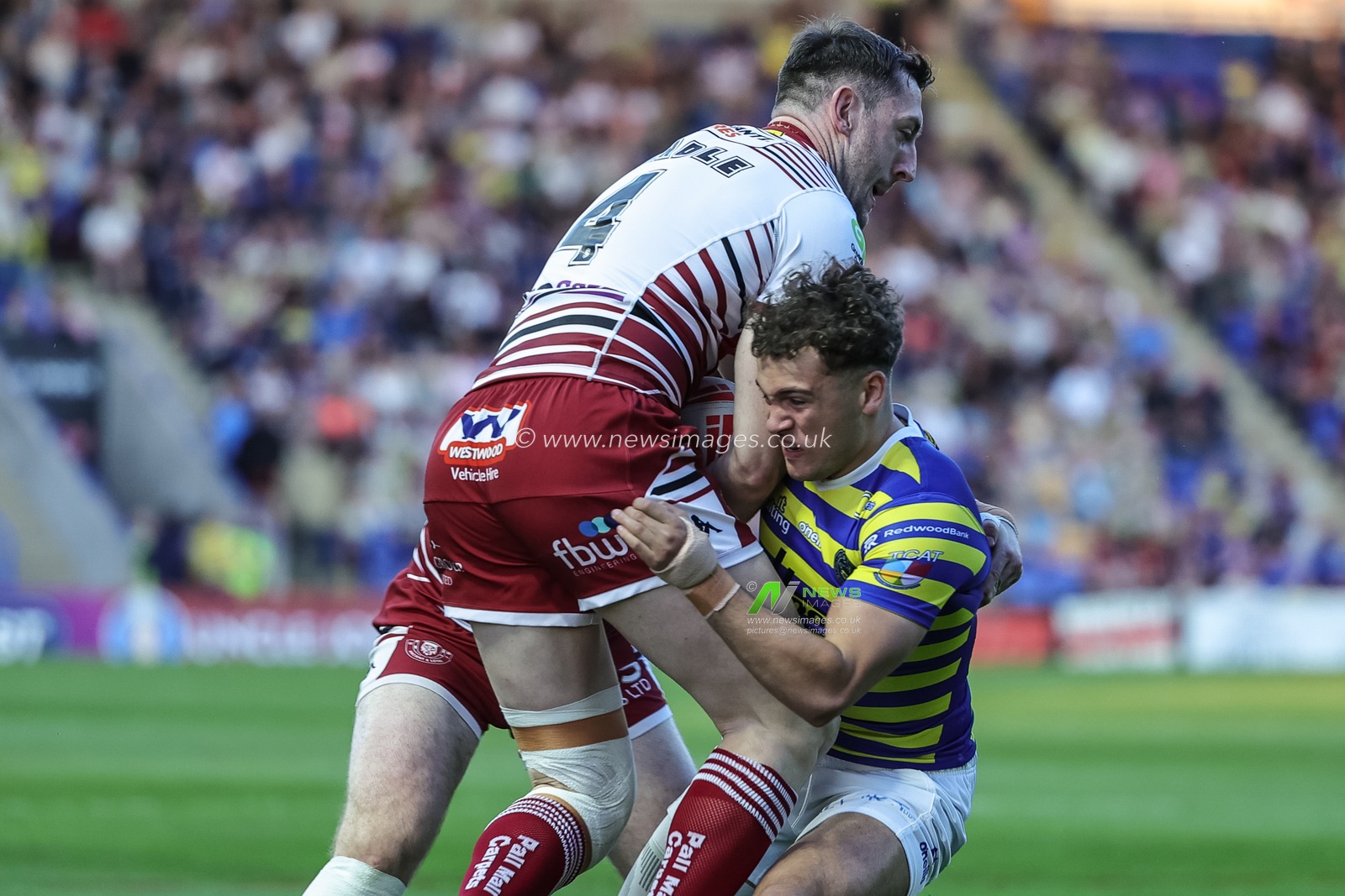 Cai Taylor-Wray of Warrington Wolves is tackled by Jai Field of Wigan Warriors and Jake Wardle of Wigan Warriors during the Betfred Super League round 9 match Warrington Wolves vs Wigan Warriors at The Halliwell Jones Stadium, Warrington, United Kingdom on 24 April 2026

(Photo by Mark Cosgrove/News Images)