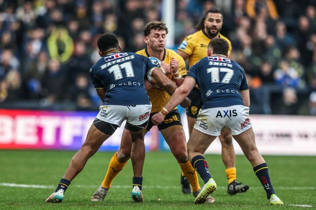 George Lawler of Castleford Tigers is tackled by Tom Holroyd of Leeds Rhinos and Cameron Smith of Leeds Rhinos during the Betfred Super League round 4 match Leeds Rhinos vs Castleford Tigers at AMT Headingley Stadium, Leeds, United Kingdom on 08 March 2026

(Photo by Alfie Cosgrove/News Images)