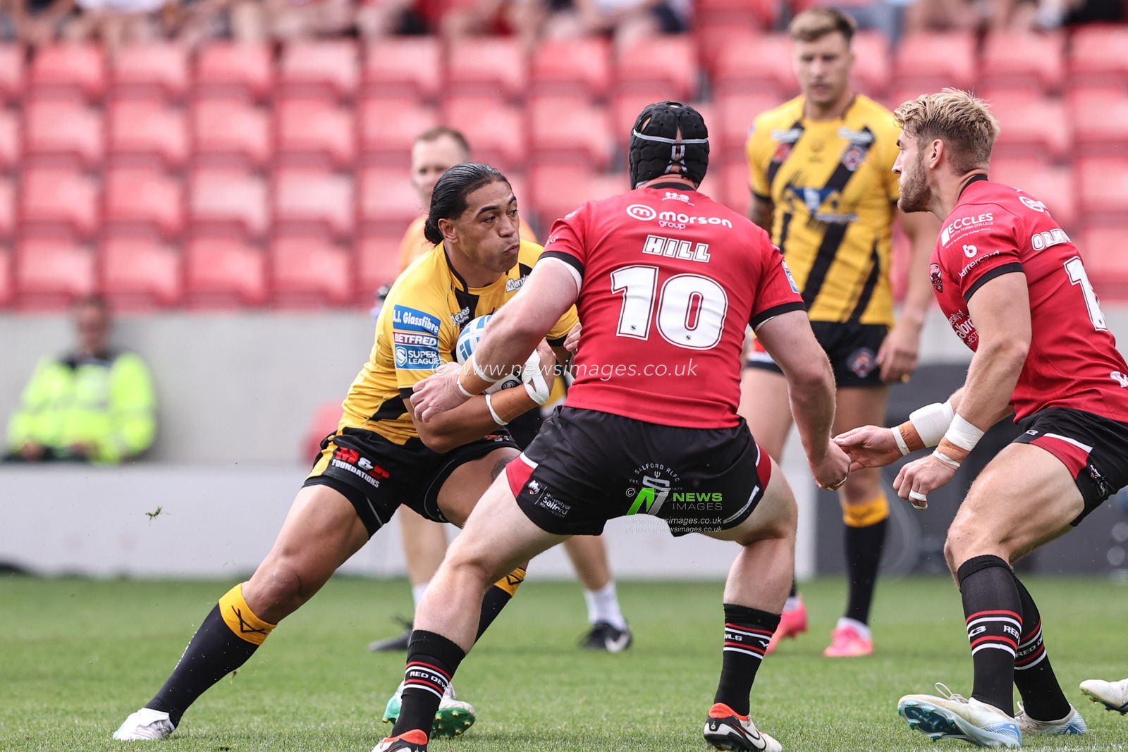 Tom Amone of Castleford Tigers is tackled during the Betfred Super League Round 18 match Salford Red Devils vs Castleford Tigers at Salford Community Stadium, Eccles, United Kingdom, 13th July 2025

(Photo by Alfie Cosgrove/News Images)