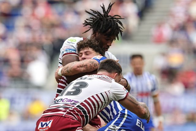 Owen Dagnall of St Helens R.F.C. is tackled by Junior Nsemba and Kaide Ellis of Wigan Warriors during the Betfred Super League Magic Weekend match Wigan Warriors vs St Helens at Hill Dickinson Stadium, Liverpool, United Kingdom on 05 July 2026

(Photo by Mark Cosgrove/News Images)