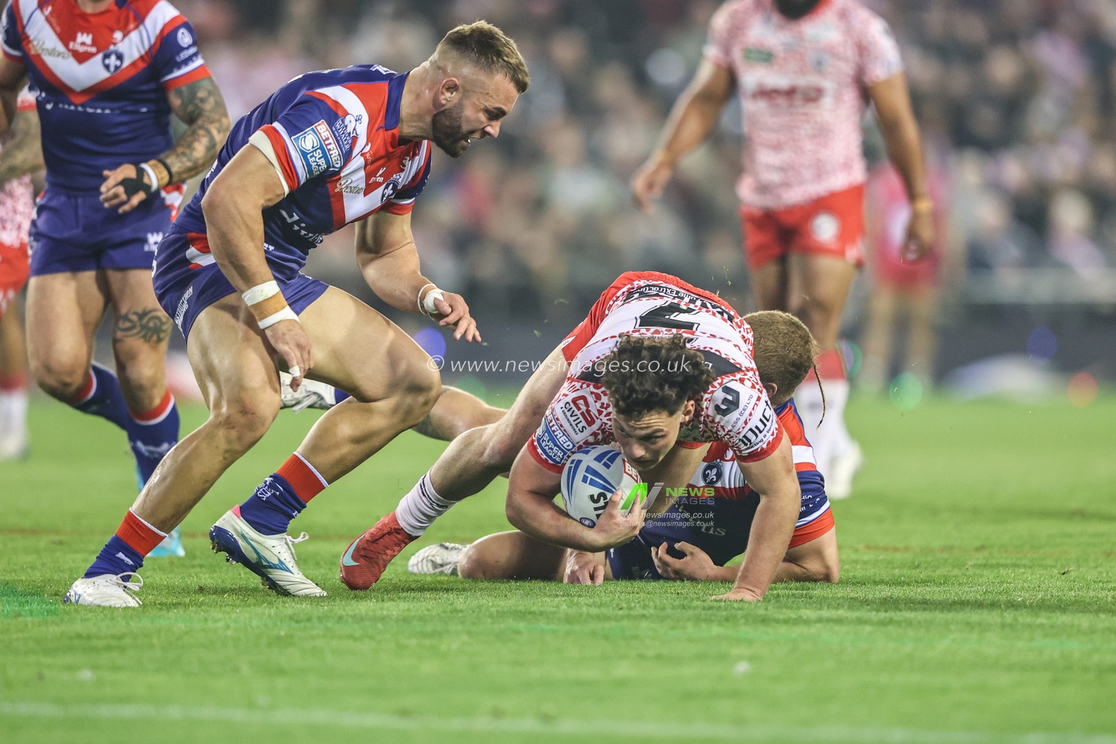 Lachlan Lam of Leigh Leopards is tackled during the Betfred Super League play-off Eliminator 1 match Leigh Leopards vs Wakefield Trinity at Progress With Unity Stadium, Leigh, United Kingdom, 26th September 2025

(Photo by Alfie Cosgrove/News Images)