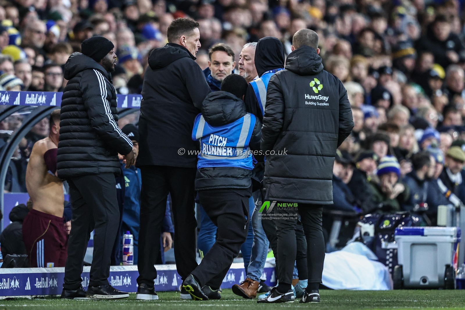 A fan is removed by security after walking onto the dugouts during the Premier League match Leeds United vs Aston Villa at Elland Road, Leeds, United Kingdom, 23rd November 2025

(Photo by Alfie Cosgrove/News Images)

*** GER AUT SUI OUT ***