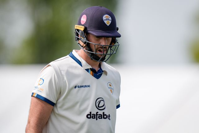 Ben Aitchison walks off after being caught by Cameron Bancroft off the bowling of Craig Miles as Gloucestershire players celebrate a wicket during the County Championship Division Two Derbyshire v Gloucestershire at The Central Co-Op County Ground, Derby, United Kingdom on 26 April 2026

(Photo by Maynard Manyowa/News Images)