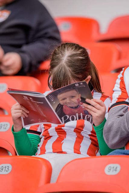 Stoke fan reads the match day program which contains an image of Oliver Royles who passed away during the Sky Bet Championship match Stoke City vs Sheffield Wednesday at Bet365 Stadium, Stoke On Trent, United Kingdom on 03 April 2026

(Photo by Maynard Manyowa/News Images)