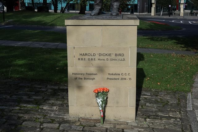 Flowers are laid at The Harold 'Dickie' Bird MBE, OBE statue after his passing today