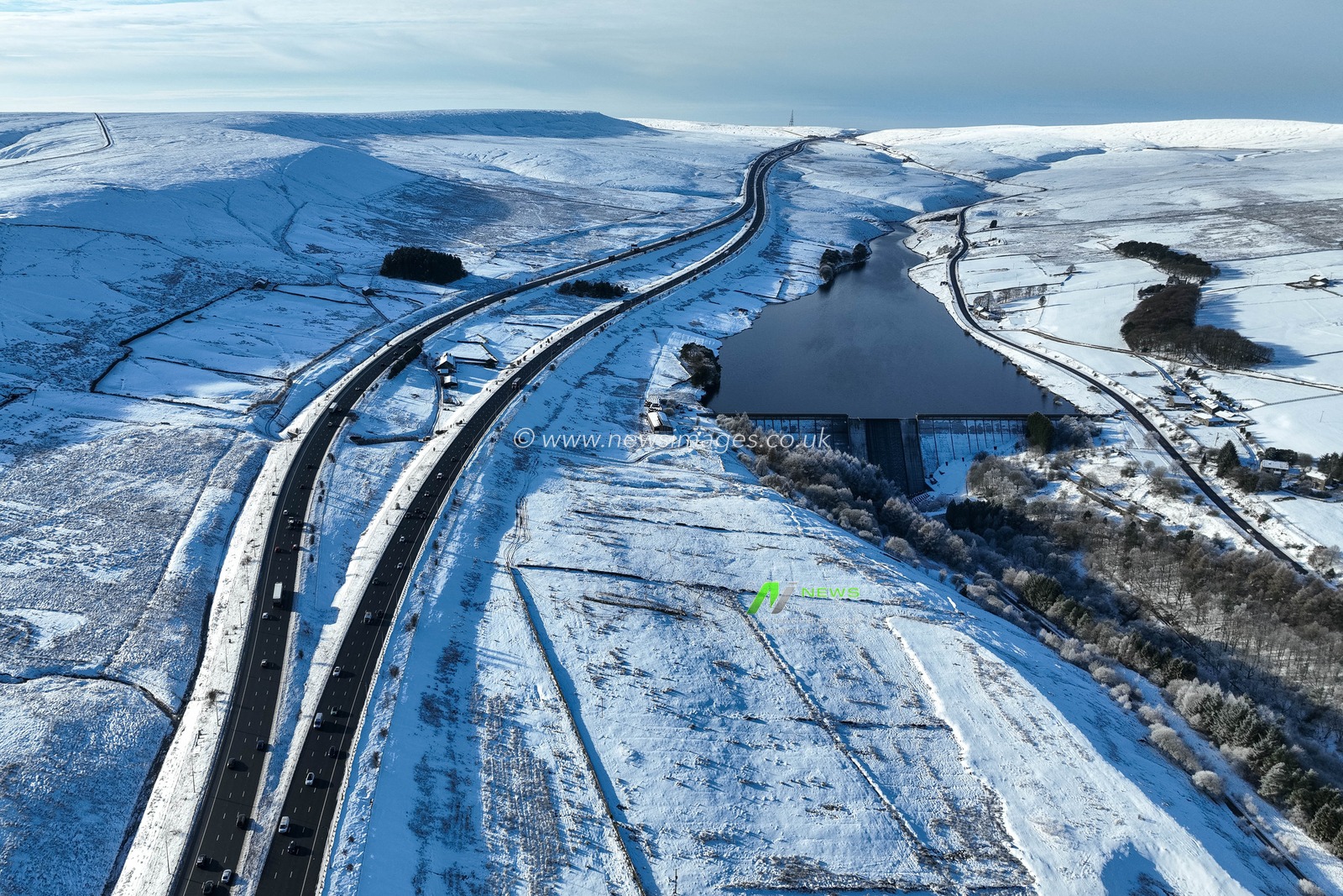 Heavy Snow over the hills of Scammonden Bridge and Booth Wood Reservoir areas of West Yorkshire and a free running M62 where the farm house sits in the middle of the motorway, Kirklees, United Kingdom, 11th January 2025

(Photo by Mark Cosgrove/News Images)