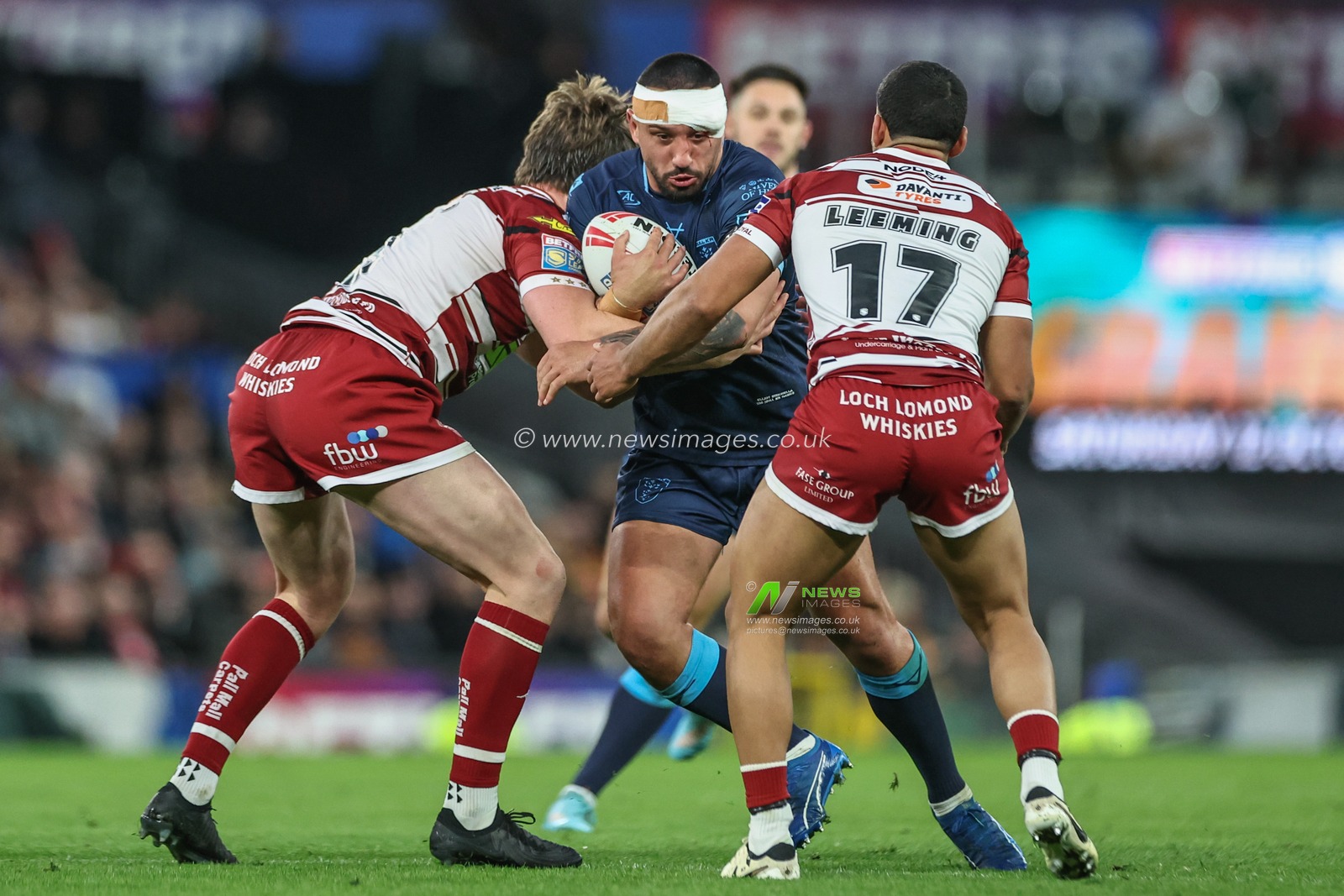 Elliot Minchella of Hull KR is tackled by Ethan Havard of Wigan Warriors and Kruise Leeming of Wigan Warriors during the Betfred Super League Grand Final match Wigan Warriors vs Hull KR at Old Trafford, Manchester, United Kingdom, 12th October 2024

(Photo by Mark Cosgrove/News Images)