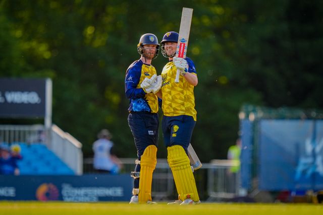 Alex Lees of Durham celebrates getting to 50 with Graham Clark of Durham by raising his bat towards the pavilion during the Vitality Blast T20 match between Derbyshire Falcons and Durham Cricket at The Central Co-Op County Ground, Derby, United Kingdom on 22 May 2026

(Photo by Maynard Manyowa/News Images)