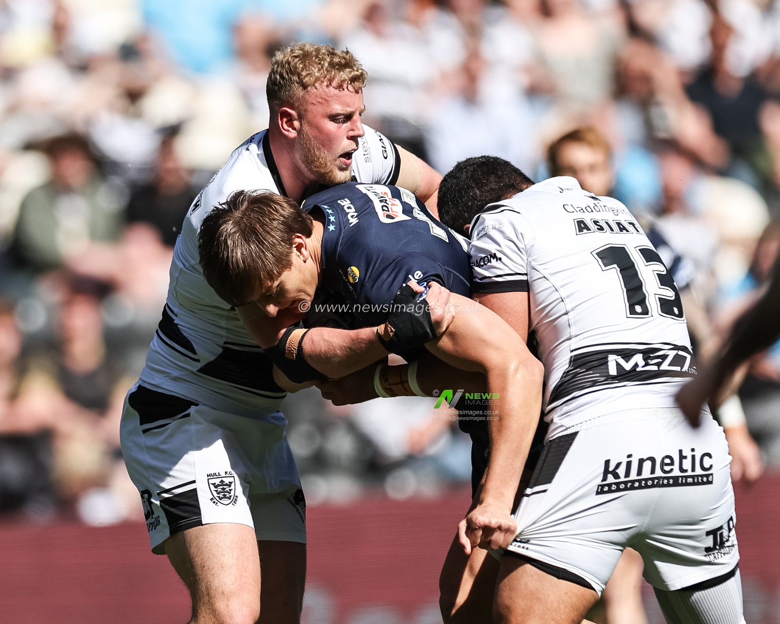 Harvey Makin of Wigan Warriors is tackled by Jack Ashworth of Hull FC and John Asiata of Hull FC during the Betfred Super League Round 9 match Hull FC vs Wigan Warriors at MKM Stadium, Hull, United Kingdom, 27th April 2025

(Photo by Mark Cosgrove/News Images)