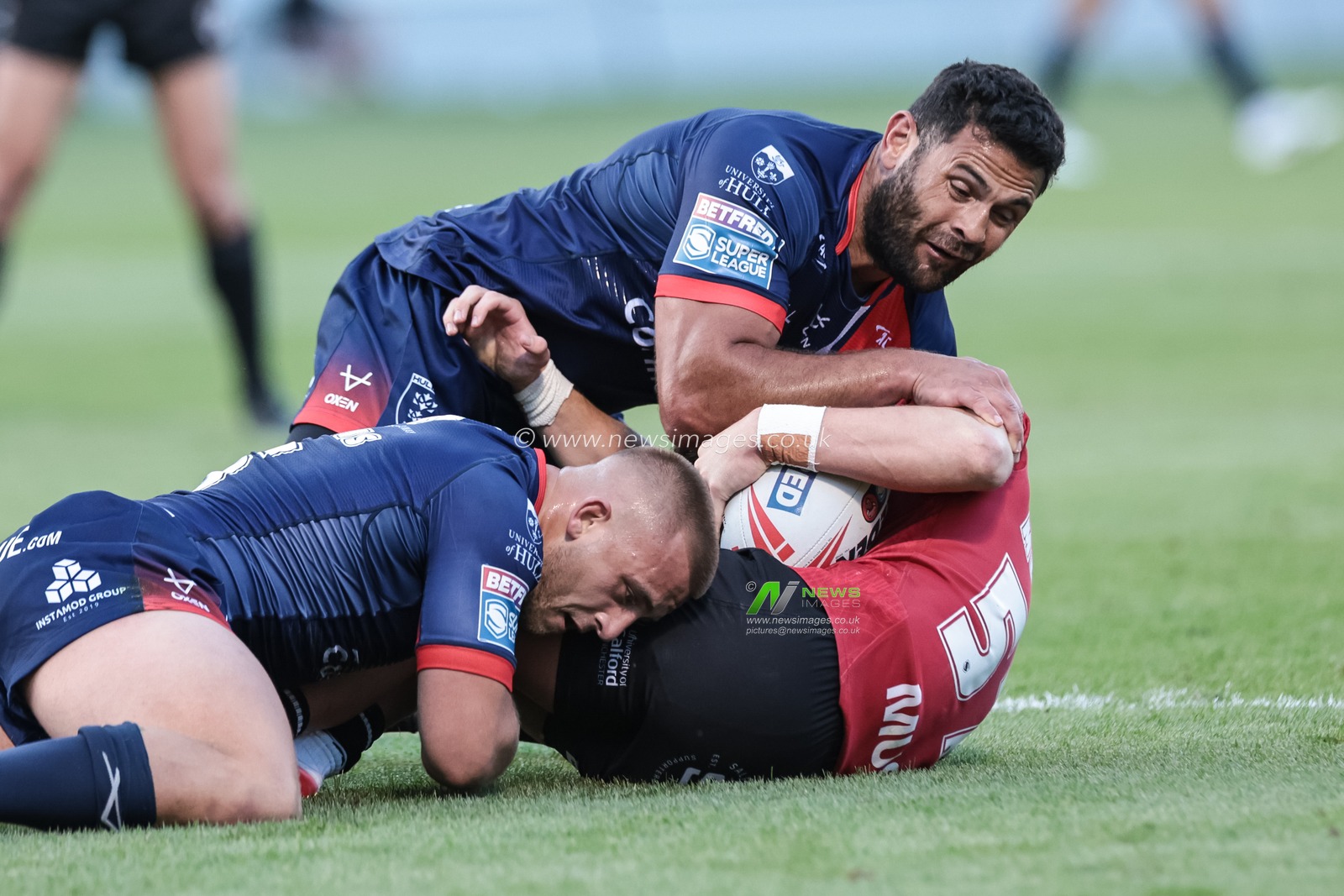Declan Murphy of Salford Red Devils is tackled by Mikey Lewis of Hull KR and Rhyse Martin of Hull KR during the Betfred Super League Round 20 Salford Red Devils vs Hull KR at Salford Community Stadium, Eccles, United Kingdom, 31st July 2025

(Photo by Mark Cosgrove/News Images)