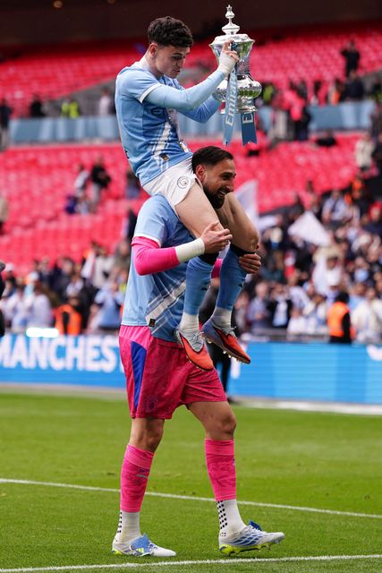 Manchester City goalkeeper Gianluigi Donnarumma and Phil Foden of Manchester City celebrate the fa cup trophy with their support during the Emirates FA Cup Final match Chelsea vs Manchester City at Wembley Stadium, London, United Kingdom on 16 May 2026

(Photo by Harvey Murphy/News Images)