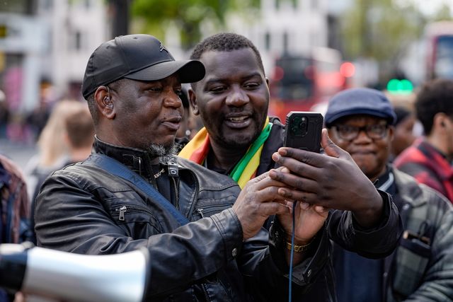 Shepherd Yuda and Makomborero Haruzvishe speak UK-based Zimbabweans gather outside the Zimbabwe Embassy in London on 18 April 2026 to protest the Constitution of Zimbabwe Amendment (No. 3) Bill, which critics say would extend President Mnangagwa’s rule until 2030 and strip citizens of the direct vote for president.

(Photo by Maynard Manyowa/News Images)