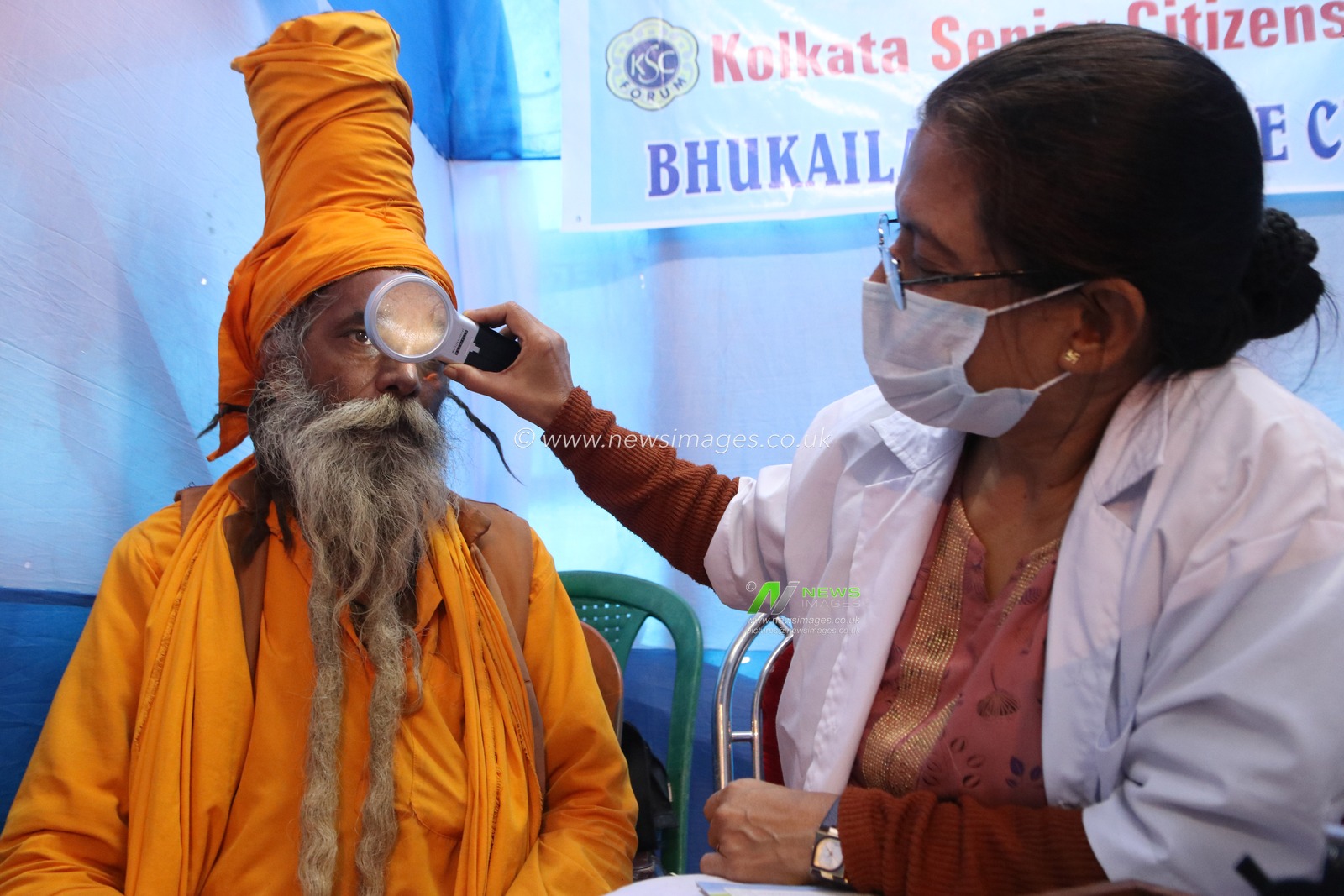 A doctor examines the eye of a Sadhu or Hindu holy man, at a free eye camp at a Gangasagar mela transit camp in Kolkata,India on January 11,2025.Picture by Debajyoti Chakraborty.(Photo: Debajyoti Chakraborty/News Images)