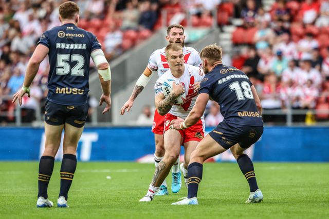 George Delaney of St. Helens is tackled by during the Betfred Super League round 16 match St Helens vs Salford Red Devils at Totally Wicked Stadium, St Helens, United Kingdom, 29th June 2025

(Photo by Alfie Cosgrove/News Images)