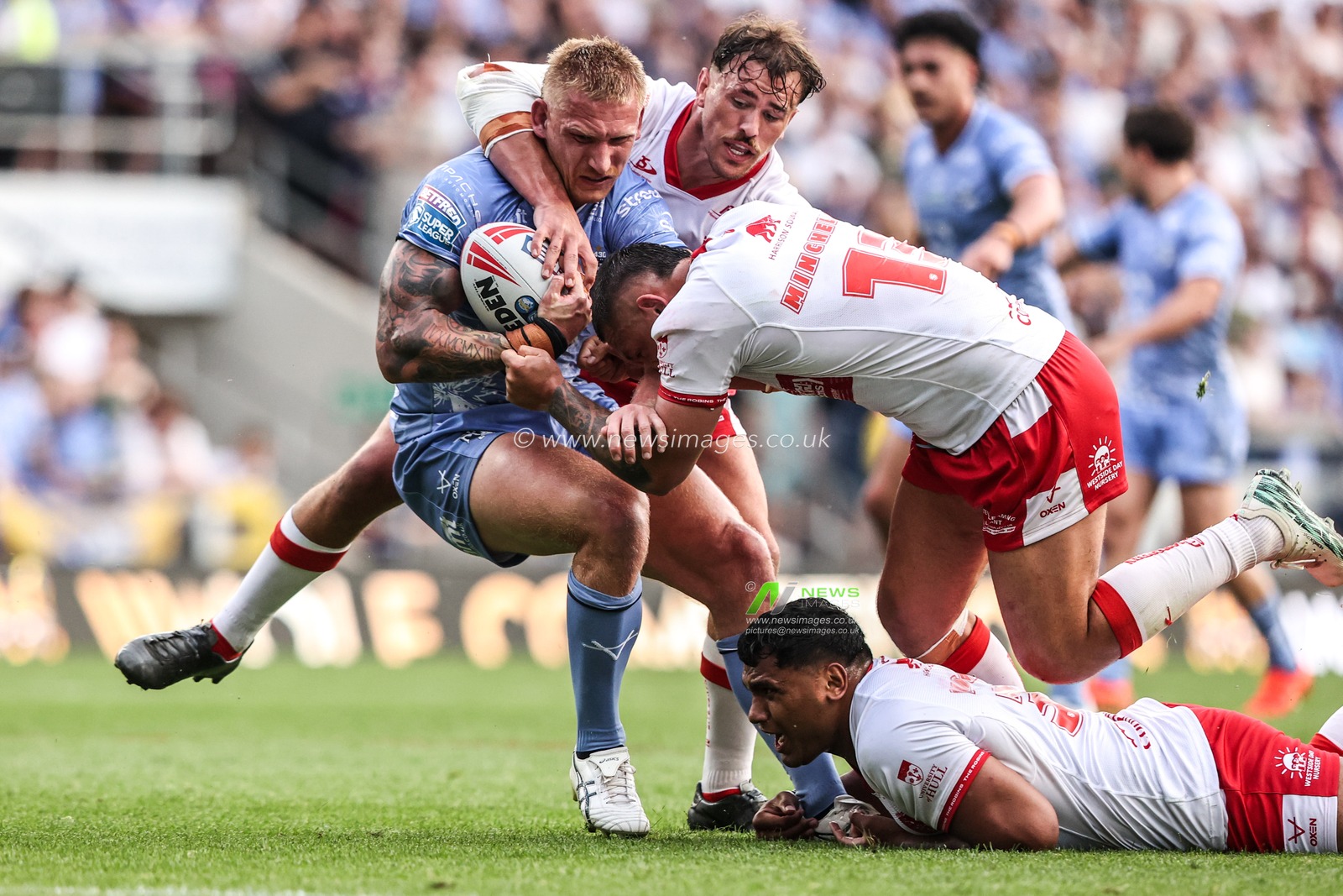 Mikołaj Olędzki of Leeds Rhinos is tackled by Elliot Minchella of Hull KR and Jai Whitbread of Hull KR during the Betfred Super League round 16 match Leeds Rhinos vs Hull KR at AMT Headingley Stadium, Leeds, United Kingdom on 26 June 2026

(Photo by Alfie Cosgrove/News Images)