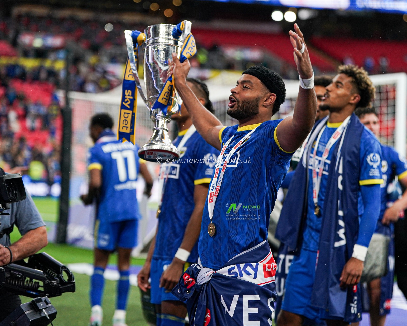 Ryan Johnson of AFC Wimbledon celebrates promotion after the Sky Bet League 2 Playoff Final match AFC Wimbledon vs Walsall at Wembley Stadium, London, United Kingdom, 26th May 2025

(Photo by Harvey Murphy/News Images)
