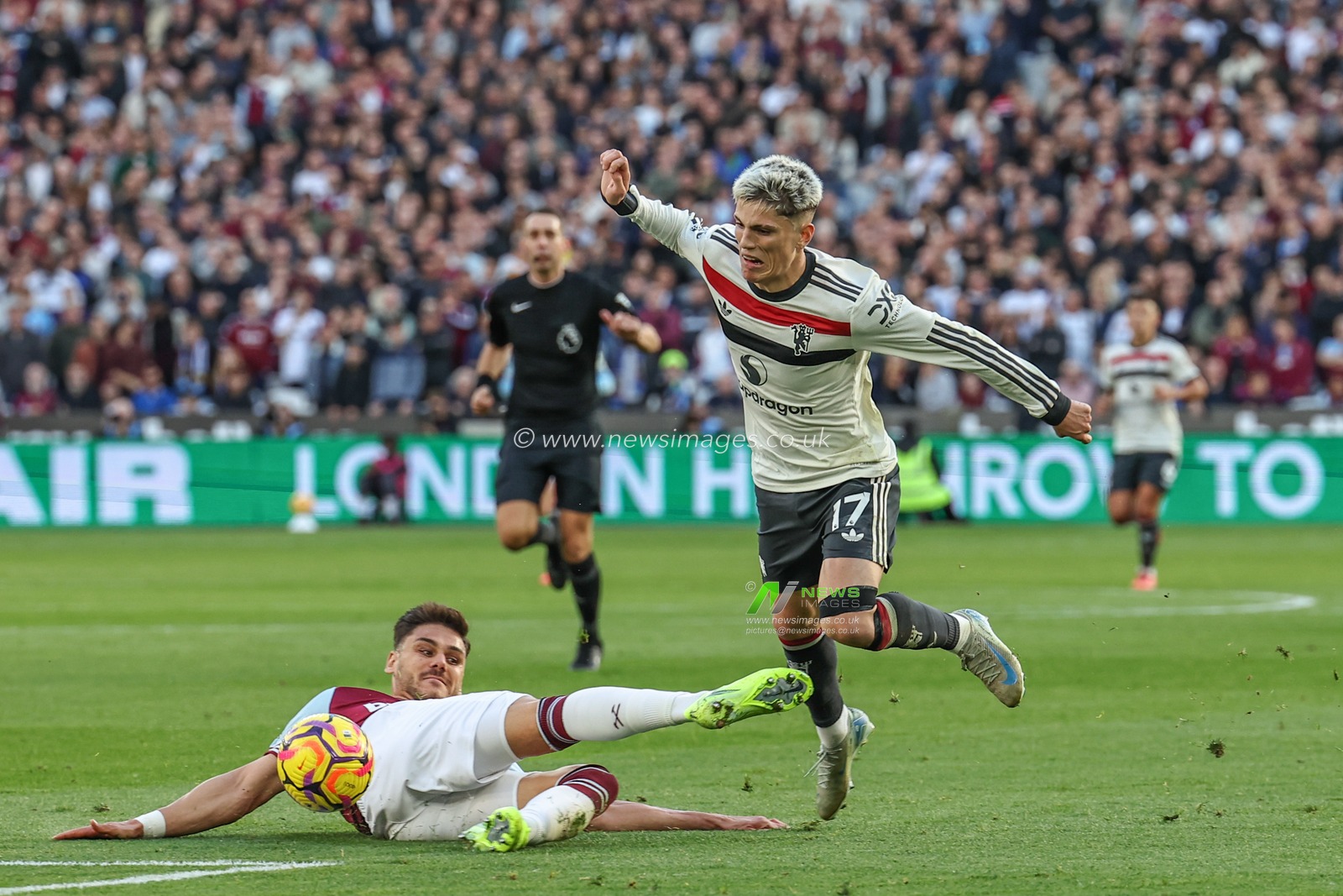 Konstantinos Mavropanos of West Ham United slides in to win the ball from Alejandro Garnacho of Manchester United during the Premier League match West Ham United vs Manchester United at London Stadium, London, United Kingdom, 27th October 2024

(Photo by Mark Cosgrove/News Images)