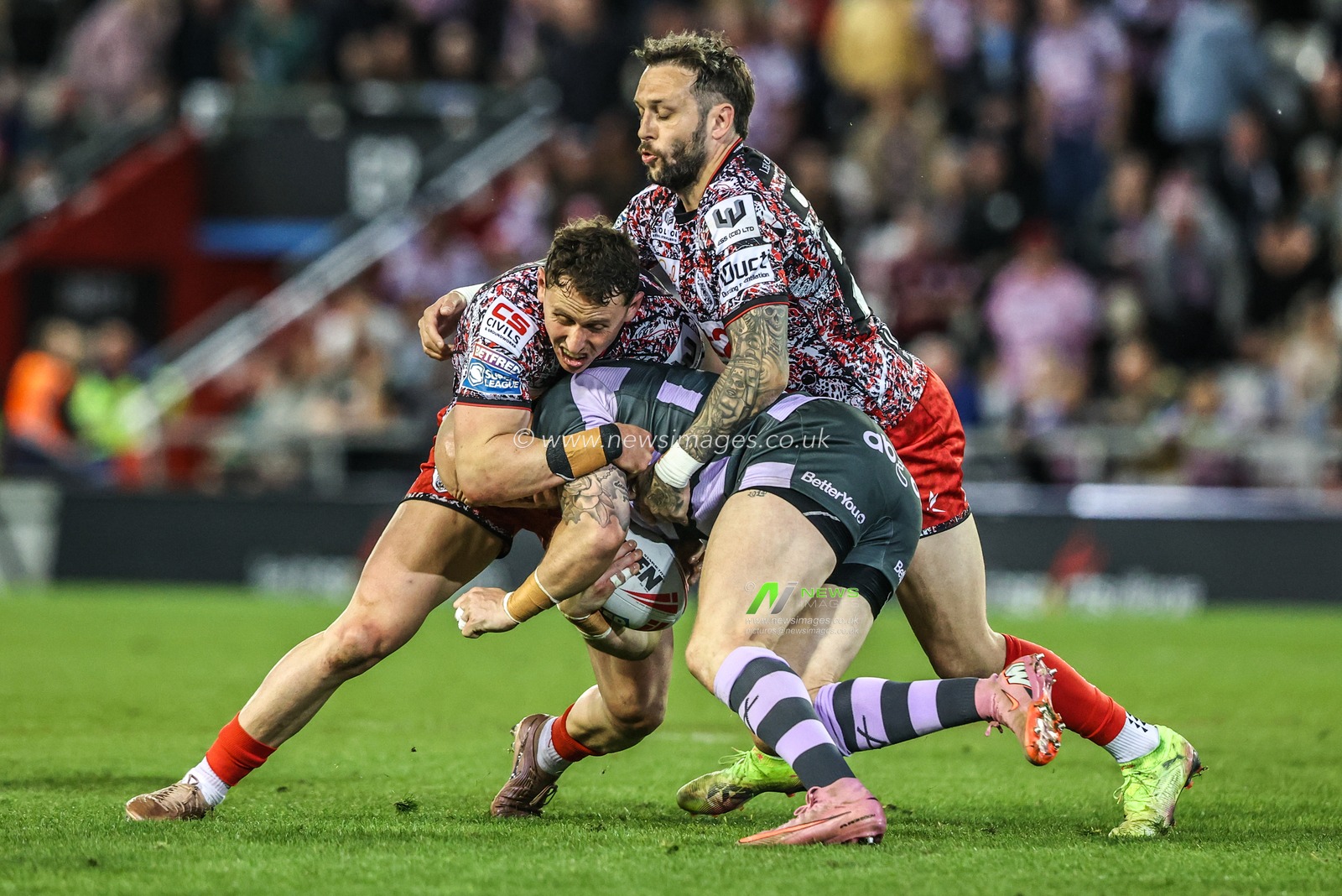 Adam Swift of Huddersfield Giants is tackled by Gareth O'Brien of Leigh Leopards and Adam Cook of Leigh Leopards during the Betfred Super League round 9 match Leigh Leopards vs Huddersfield Giants at Leigh Sports Village, Leigh, United Kingdom on 23 April 2026

(Photo by Alfie Cosgrove/News Images)