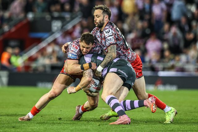Adam Swift of Huddersfield Giants is tackled by Gareth O'Brien of Leigh Leopards and Adam Cook of Leigh Leopards during the Betfred Super League round 9 match Leigh Leopards vs Huddersfield Giants at Leigh Sports Village, Leigh, United Kingdom on 23 April 2026

(Photo by Alfie Cosgrove/News Images)