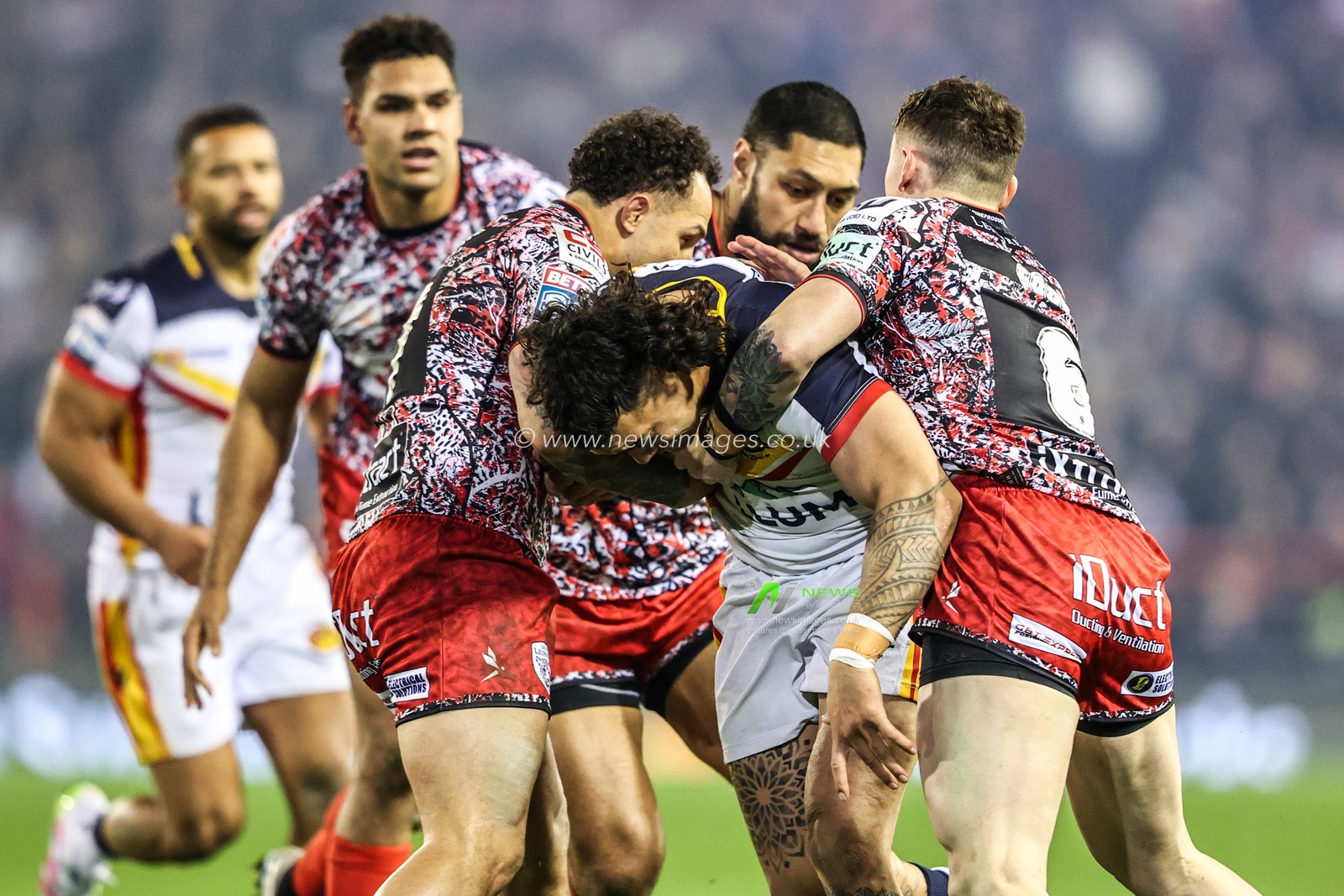 Charlie Staines of Catalans Dragons is tackled by Liam Horne of Leigh Leopards and Adam Cook of Leigh Leopards during the Betfred Super League match Leigh Leopards vs Catalans Dragons at Leigh Sports Village, Leigh, United Kingdom on 06 March 2026

(Photo by Alfie Cosgrove/News Images)