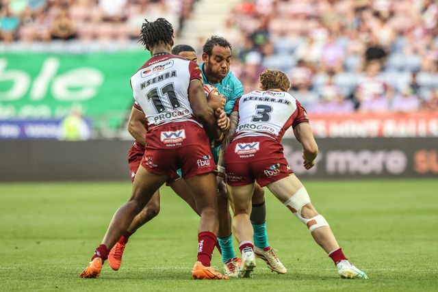 Leroy Cudjoe of Huddersfield Giants is tackled by Junior Nsemba of Wigan Warriors and Adam Keighran of Wigan Warriors during the Betfred Super League round 18 match Wigan Warriors vs Huddersfield Giants at The Brick Community Stadium, Wigan, United Kingdom, 11th July 2025

(Photo by Alfie Cosgrove/News Images)