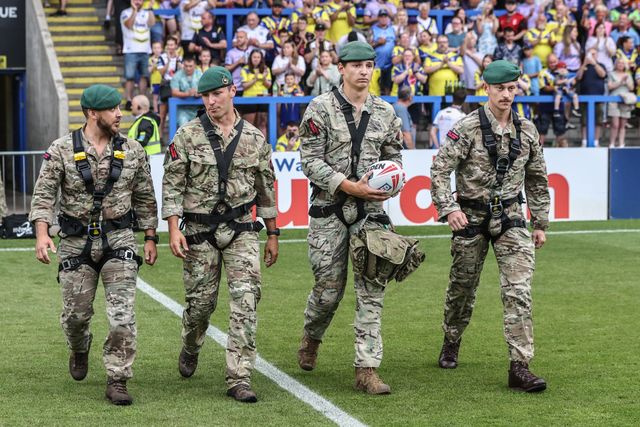 The British Marines deliver the match ball during the Betfred Super League round 15 match Warrington Wolves vs Huddersfield Giants at Halliwell Jones Stadium, Warrington, United Kingdom, 21st June 2025

(Photo by Alfie Cosgrove/News Images)